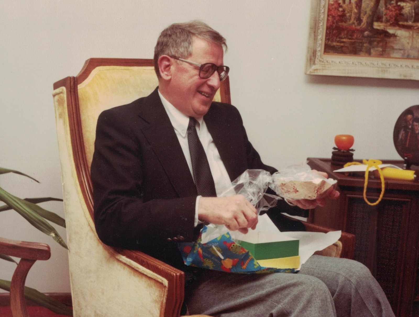 Dan opening a gift at a celebration
